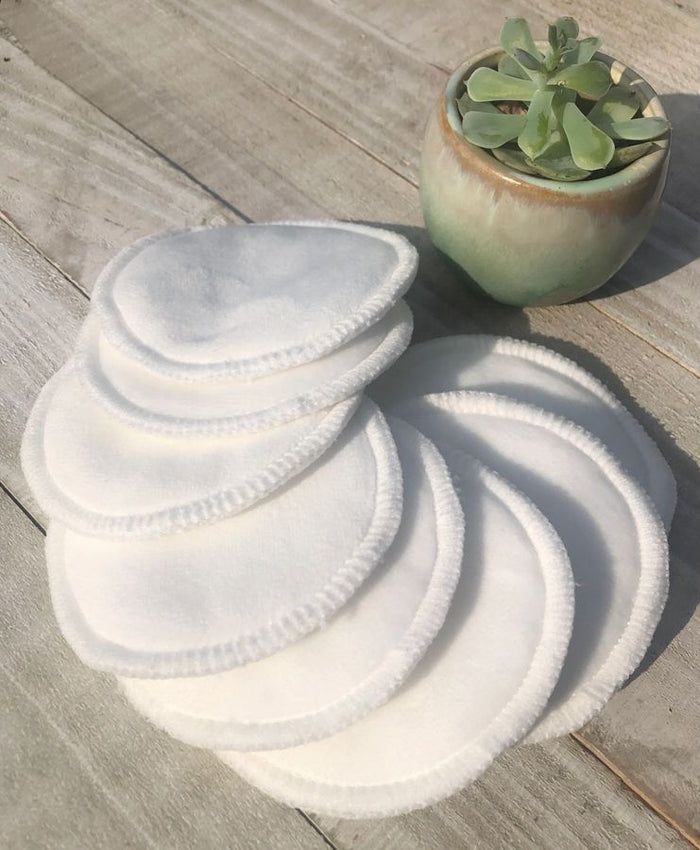 Eco-Friendly Bamboo Cotton Reusable Face Rounds in soft, off-white fabric with stitched edges, stacked in a fanned arrangement