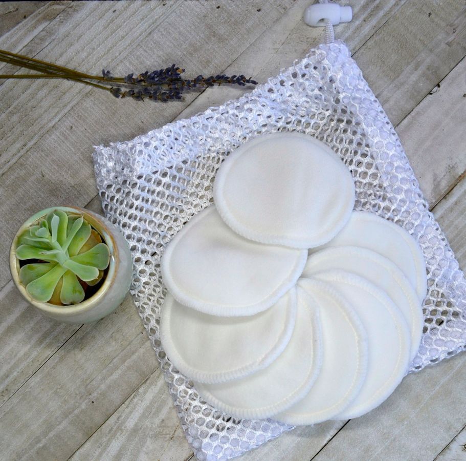 Eco-Friendly Bamboo Cotton Reusable Face Rounds in soft off-white, set of seven, displayed on a white mesh laundry bag with a small succulent plant nearby