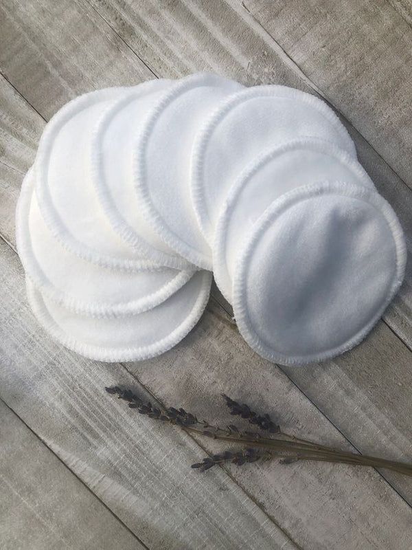 Eco-Friendly Bamboo Cotton Reusable Face Rounds in soft white fabric, round shape with stitched edges, arranged on wooden surface