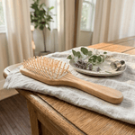 Eco-friendly bamboo paddle hairbrush with natural wooden bristles and rubber cushion for sensitive scalps