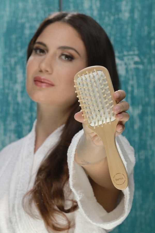 Eco-friendly bamboo paddle brush with natural wood grain and rubber cushion