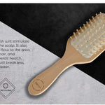 Eco-friendly bamboo paddle brush with natural wooden bristles and rubber cushion for detangling and scalp massage