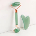 Gua Sha Board and facial roller set in smooth green natural resin with contoured edges and polished finish for massage.