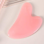 Heart-shaped rose quartz gua sha tool for facial massage and contouring