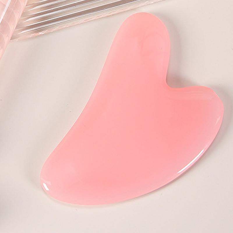 Heart-shaped rose quartz gua sha tool for facial massage and contouring