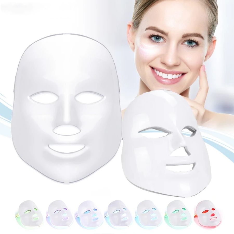 Light Therapy LED Face Mask in white plastic with smooth surface, eye, nose, and mouth cutouts, shown with a smiling woman.