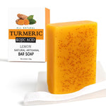 Natural Turmeric Soap bar in bright yellow with small dark exfoliating specks, shown next to its white and orange lemon-scented box packaging.