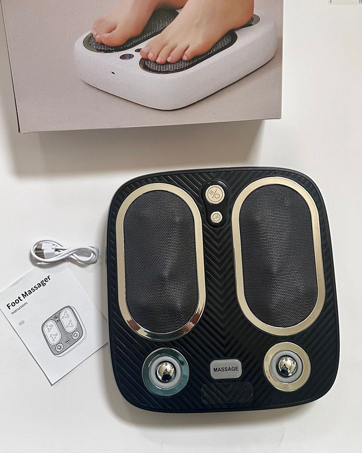 Stress & Pain Relief Foot Massager in black with carbon fiber texture, dual foot pads, two silver rolling knobs, and control buttons