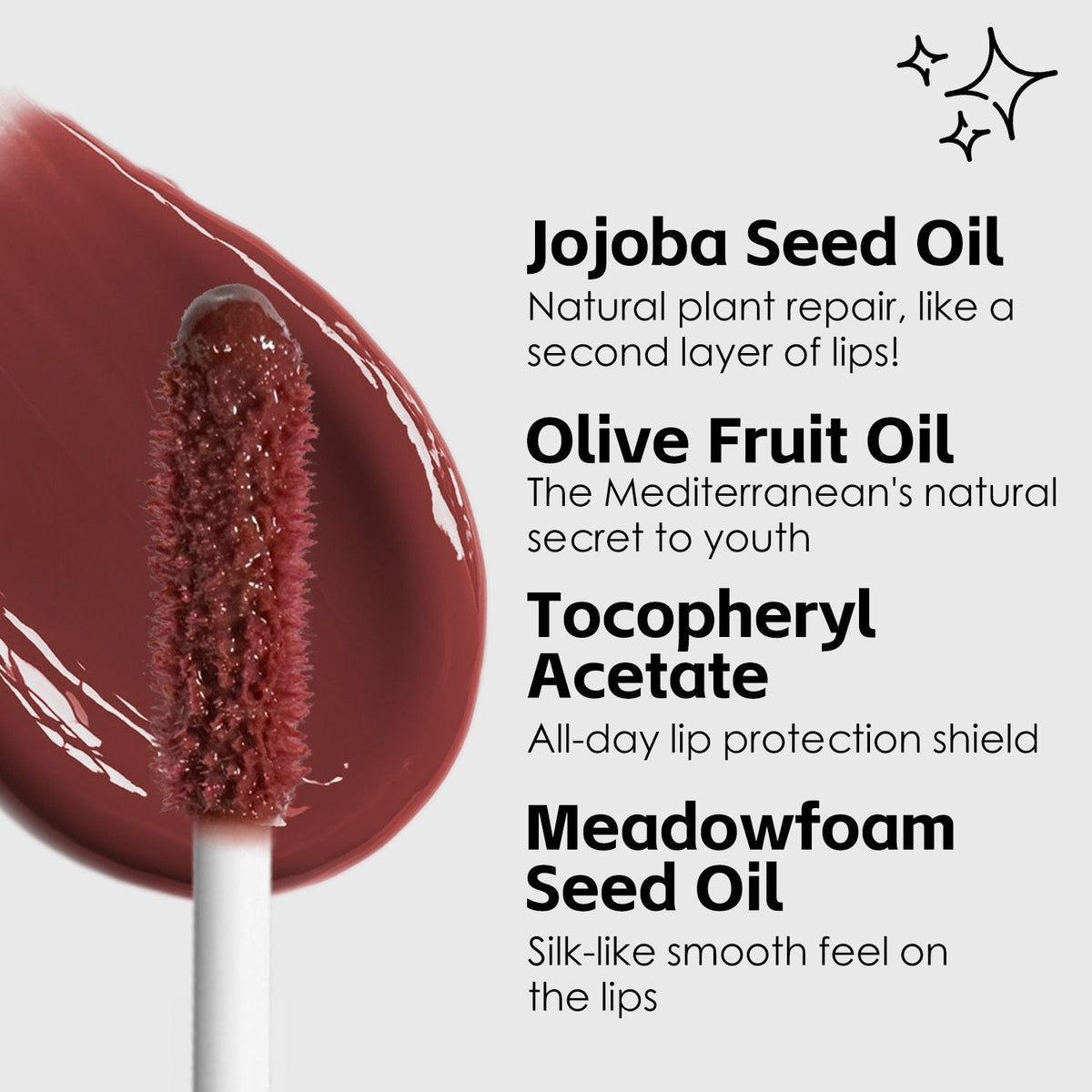 Ultra-Hydrating Lip Gloss wand with deep berry shade and smooth, glossy texture highlighting jojoba seed oil and natural oils benefits
