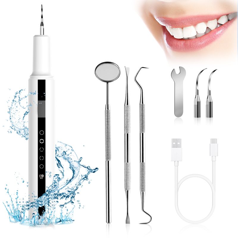 Ultrasonic Teeth Cleaner in white with black display panel, includes stainless steel dental tools, USB cable, and dual cleaning tips.